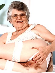 Grandma Carol takes the time out to spread her pussy lips wide wearing her white sheer stockings