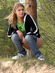 Beautiful teen plays watersports on a quiet forest glade